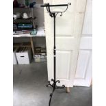 A wrought iron adjustable plant stand
