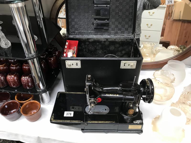 A Singer (222K) sewing machine in case