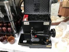 A Singer (222K) sewing machine in case