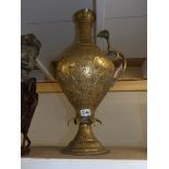 A large brass ewer with cobra handle.