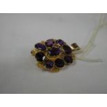 A gold brooch converted to pendant set with amethysts (No Hall mark, tested as gold).