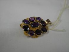 A gold brooch converted to pendant set with amethysts (No Hall mark, tested as gold).