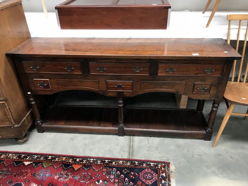 A dark oak dresser base