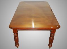 A Victorian mahogany wind out extending dining table complete with handle.