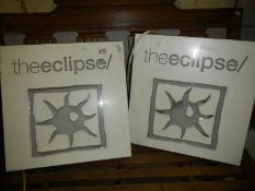 A pair of illuminating signs 'The Eclipse'.