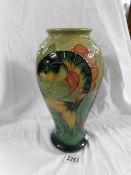 A Moorcroft carp vase designed by Sally Tuffin.