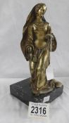 A Victorian metal figure on marble base.