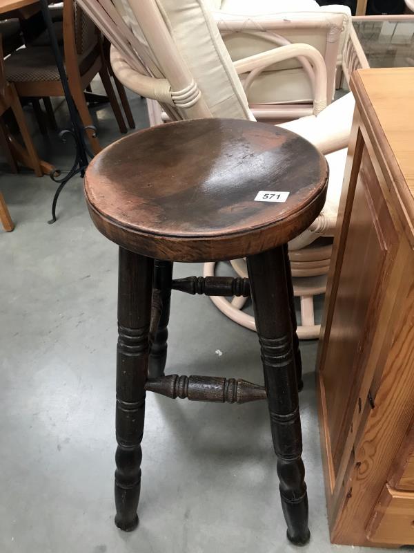 A wooden bar/kitchen stool