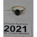 A 9ct gold ring set with central French jet with white stone shoulders, hall marked Birmingham 1987.