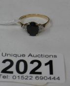 A 9ct gold ring set with central French jet with white stone shoulders, hall marked Birmingham 1987.