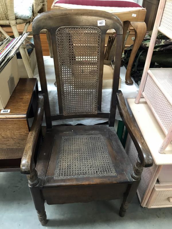 An Edwardian mahogany carver chair commode with bergiere seat and back panels