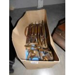 A box of old brass door handles and window catches.