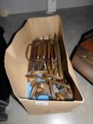 A box of old brass door handles and window catches.