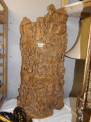 A heavily carved tribal plaque.