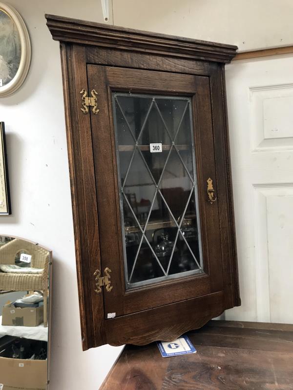 A lead glazed corner cabinet