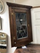 A lead glazed corner cabinet