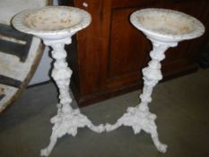 A pair of cast iron bird baths.