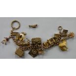 A 9ct gold charm bracelet with charms including 7 9ct gold George Jensen charms including