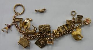 A 9ct gold charm bracelet with charms including 7 9ct gold George Jensen charms including