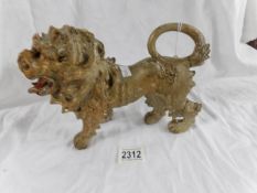 An antique carved wood lion.