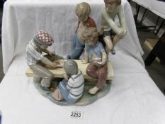 A large NAO by Lladro tableau piece of boys playing cards.