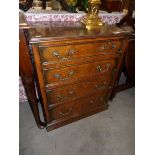 A 20th century walnut veneer 4 drawer chest.