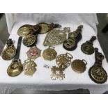 15 horse brasses including some on leathers and a brass trivet.