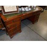 A good mahogany double pedestal desk with green leather inset top.