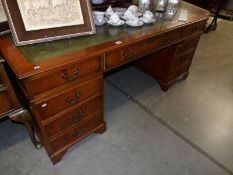 A good mahogany double pedestal desk with green leather inset top.