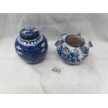 A blue and white oriental ginger jar and a Delft style blue and white pot.