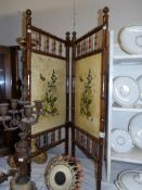A 2 fold bamboo screen with floral panels.
