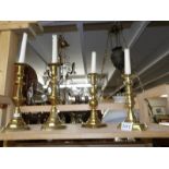 A pair of Victorian brass candlesticks and 2 odd brass candlesticks.