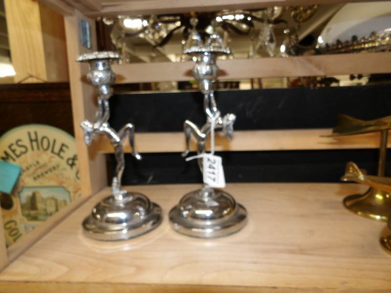 A pair of chrome art deco nude figurine candlesticks.