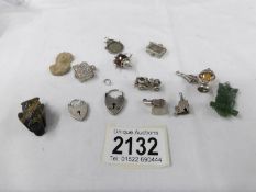 A quantity of charms including some silver, 2 stone owls etc.