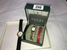 A boxed Gucci watch and a Yves St.