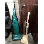 A vintage hoover vacuum cleaner and 1 other