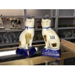 A pair of Staffordshire style cat figures