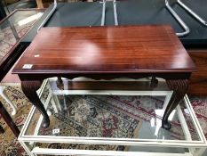 A darkwood stained coffee table with string inlay