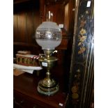 A Victorian brass oil lamp with later shade.