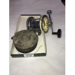 A multiplier fishing reel and an old fishing reel