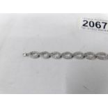 A diamond bracelet fashioned as ovals in 18ct white gold (10 grams).