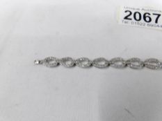 A diamond bracelet fashioned as ovals in 18ct white gold (10 grams).