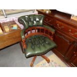 A mahogany and leather executive chair.