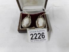 A pair of cameo earrings.