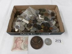 A mixed lot of old coins including some silver.