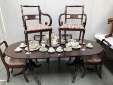 An extending dining table with 6 chairs including 2 carvers featuring gold leaf decoration