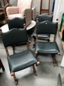 A set of 4 oak chairs with green leather seat and back panels