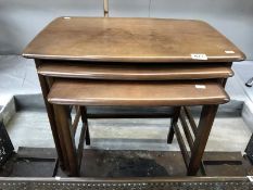 A set of darkwood stained nest of tables