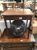 An oak side table with dummy drawer