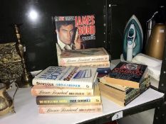 A quantity of hard back and paperback books including James Bond